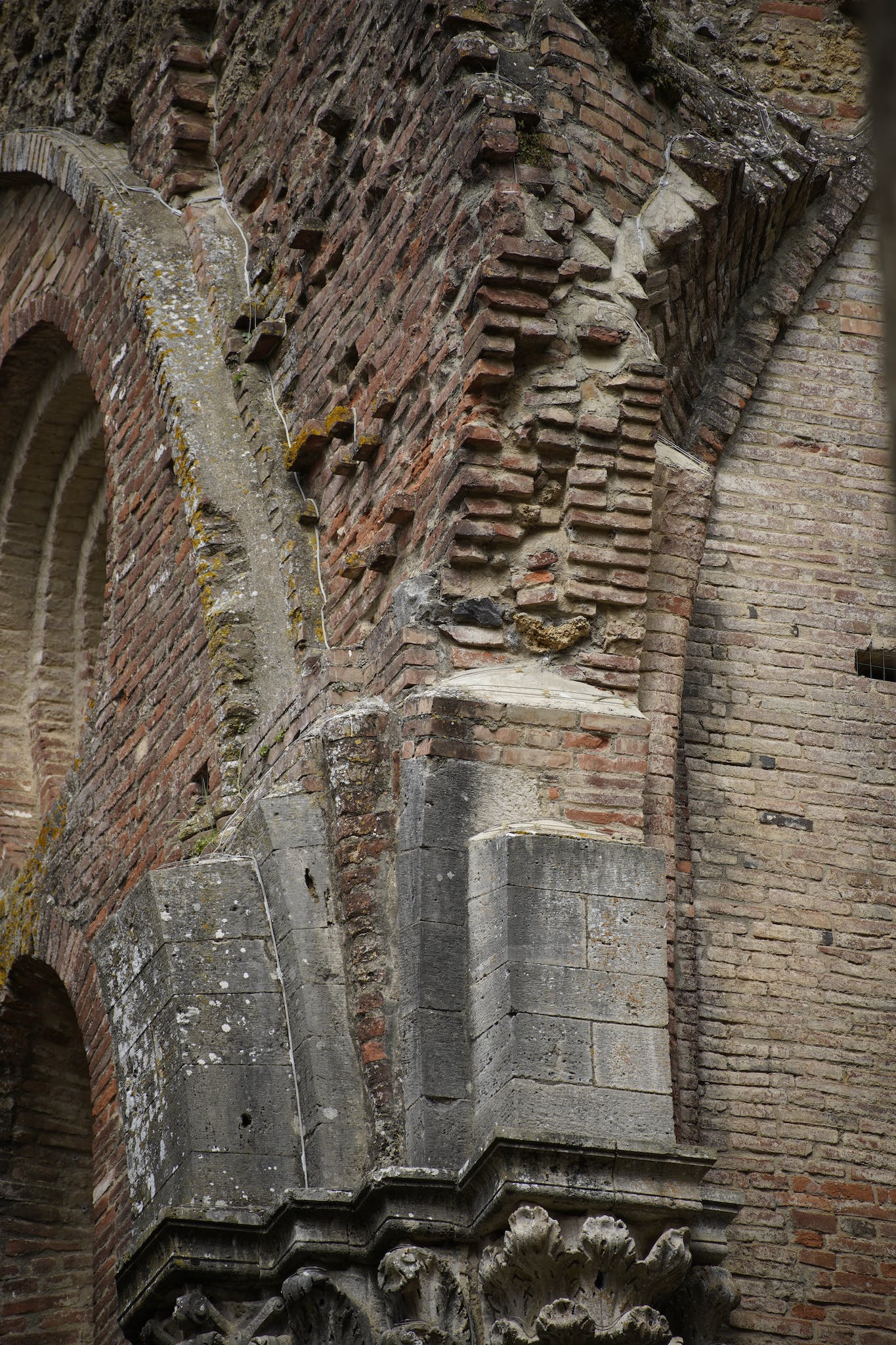 A close up of a brick building with a clock