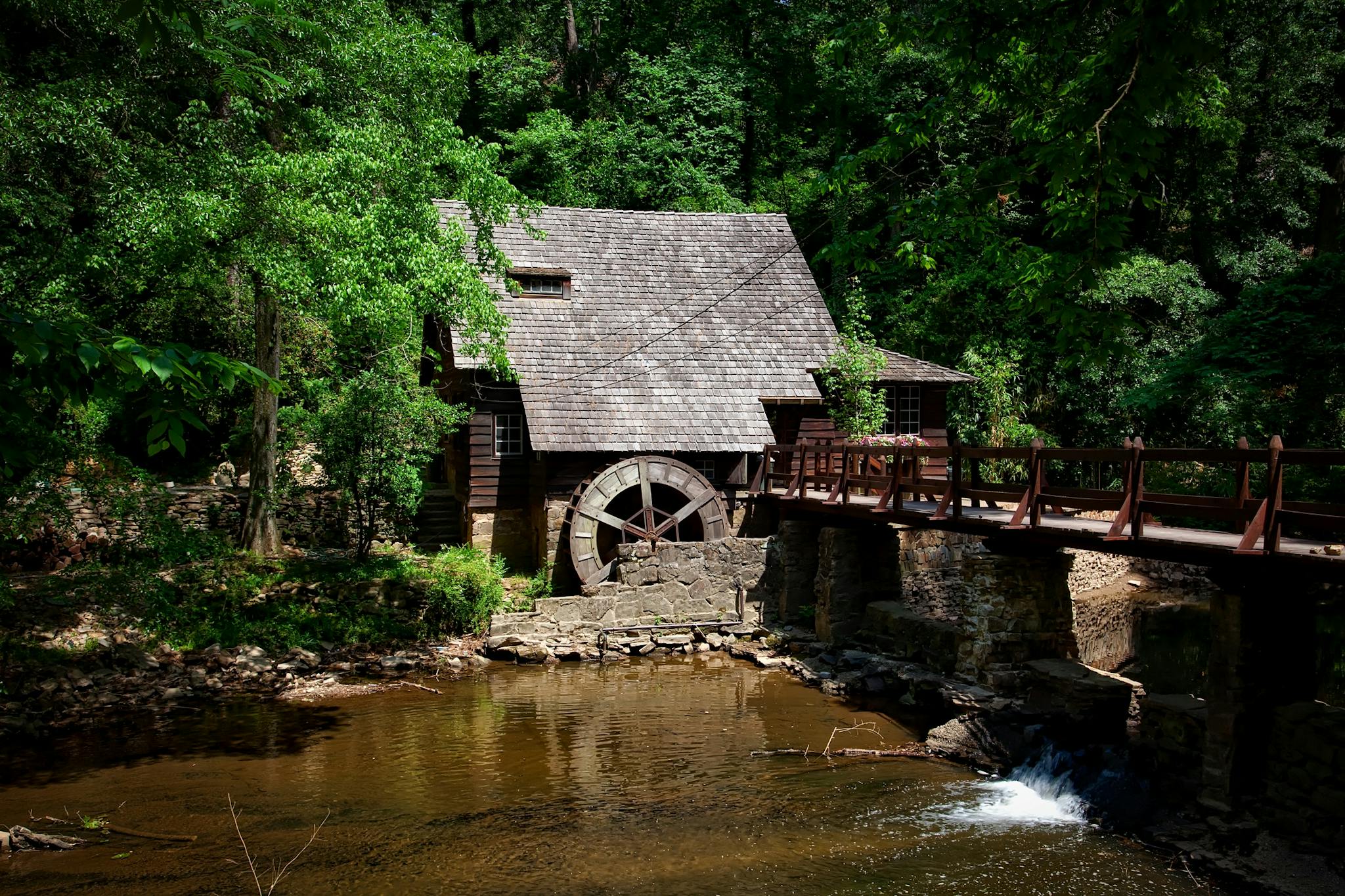 Brown House Near River Trees and Bridge